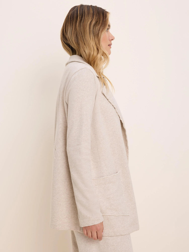 Heathered oatmeal long jacket with soft lapel collar, open front, and two patch pockets with raw edge detailing.