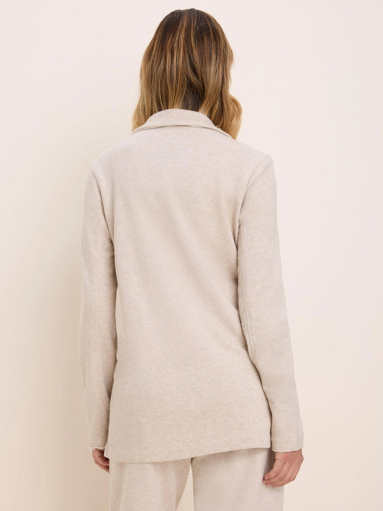 Oatmeal French Terry long jacket on model from back. Features a collar, long sleeves, and a relaxed fit.