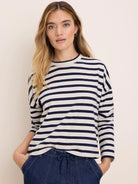 Cream long-sleeve tee with horizontal navy stripes and a crew neck.