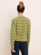 Relaxed long-sleeve tee with chartreuse and dark grey horizontal stripes.