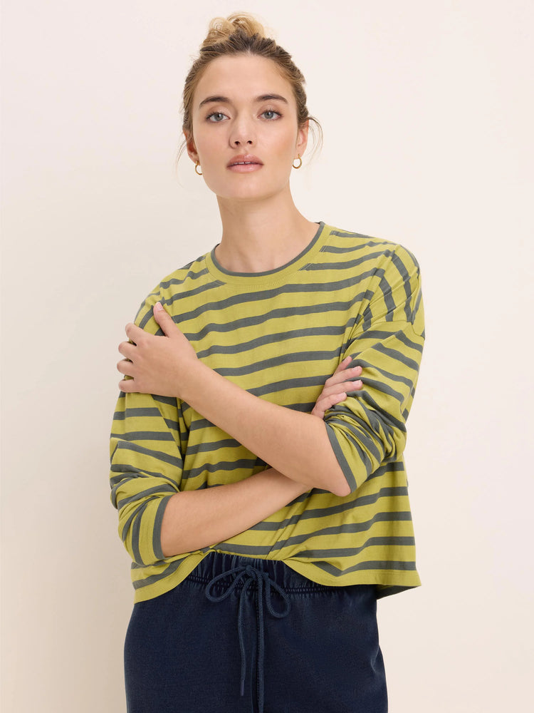 Relaxed fit, long-sleeve, crew neck tee with horizontal greenish-yellow and dark gray stripes.