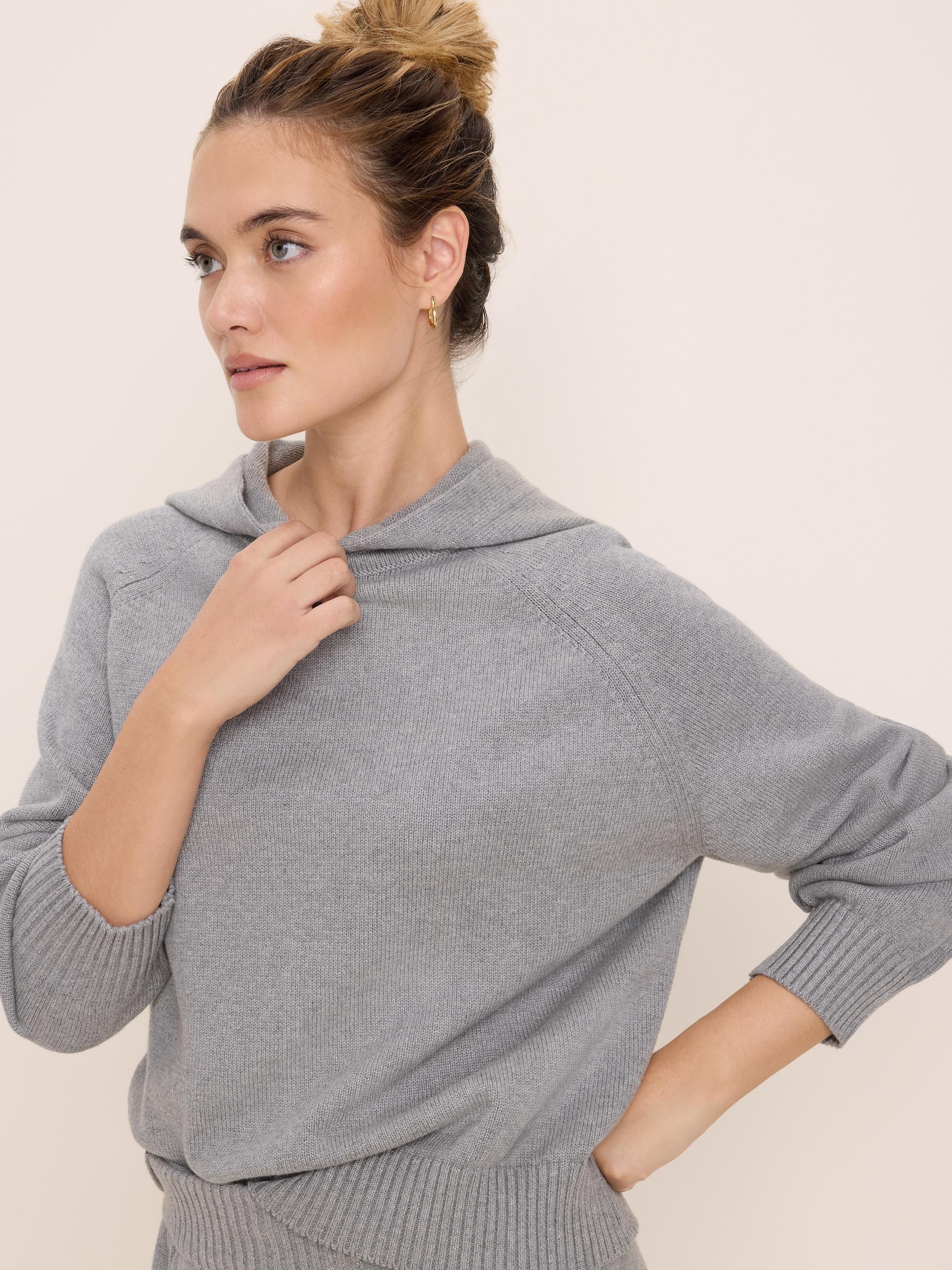 Light grey knit sweater hoodie with raglan sleeves, ribbed cuffs and hem.