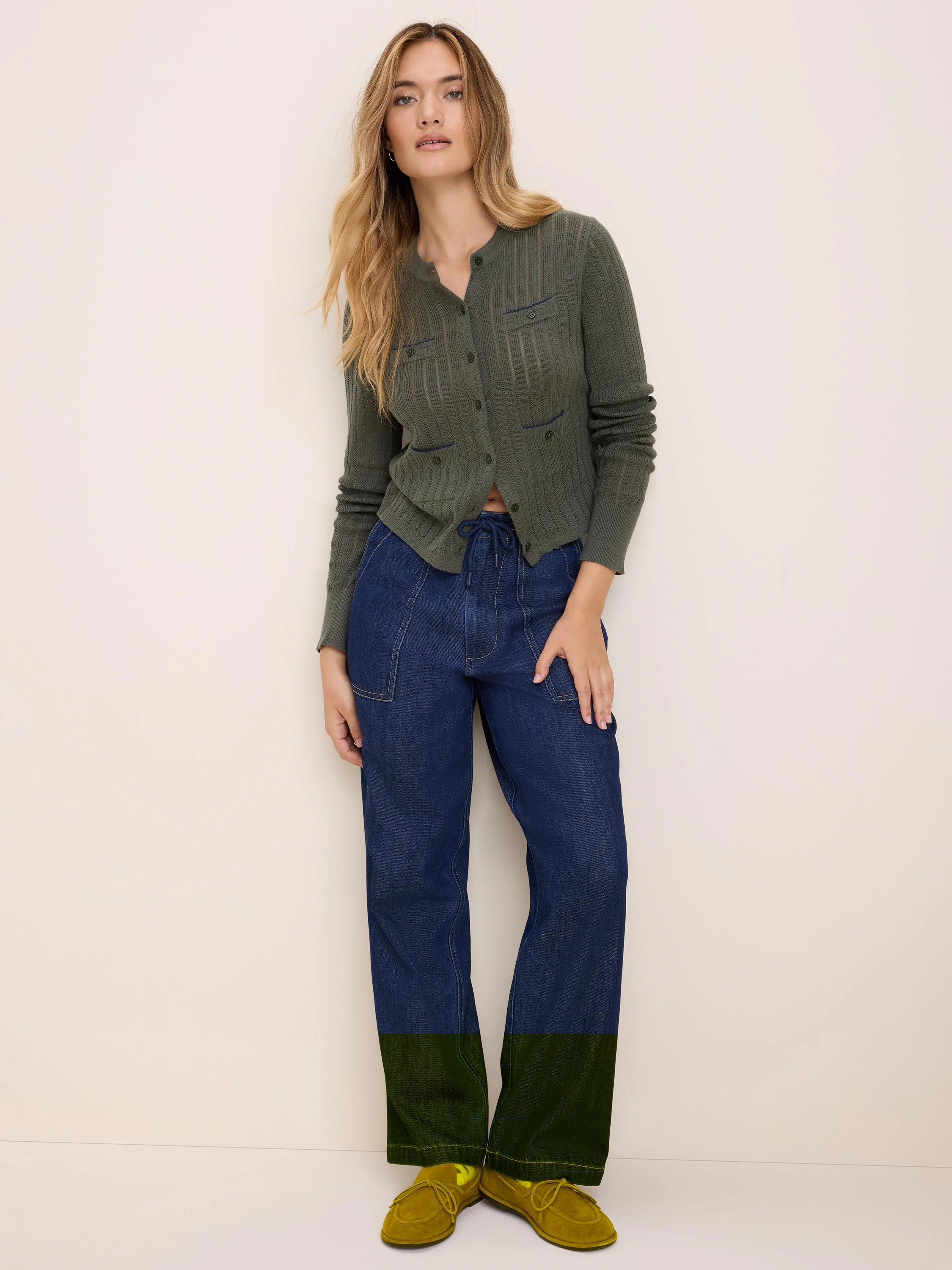 Olive green pointelle knit cardigan with a button-front and two buttoned chest pockets.