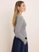 Light gray pointelle knit cardigan with a small patch pocket.