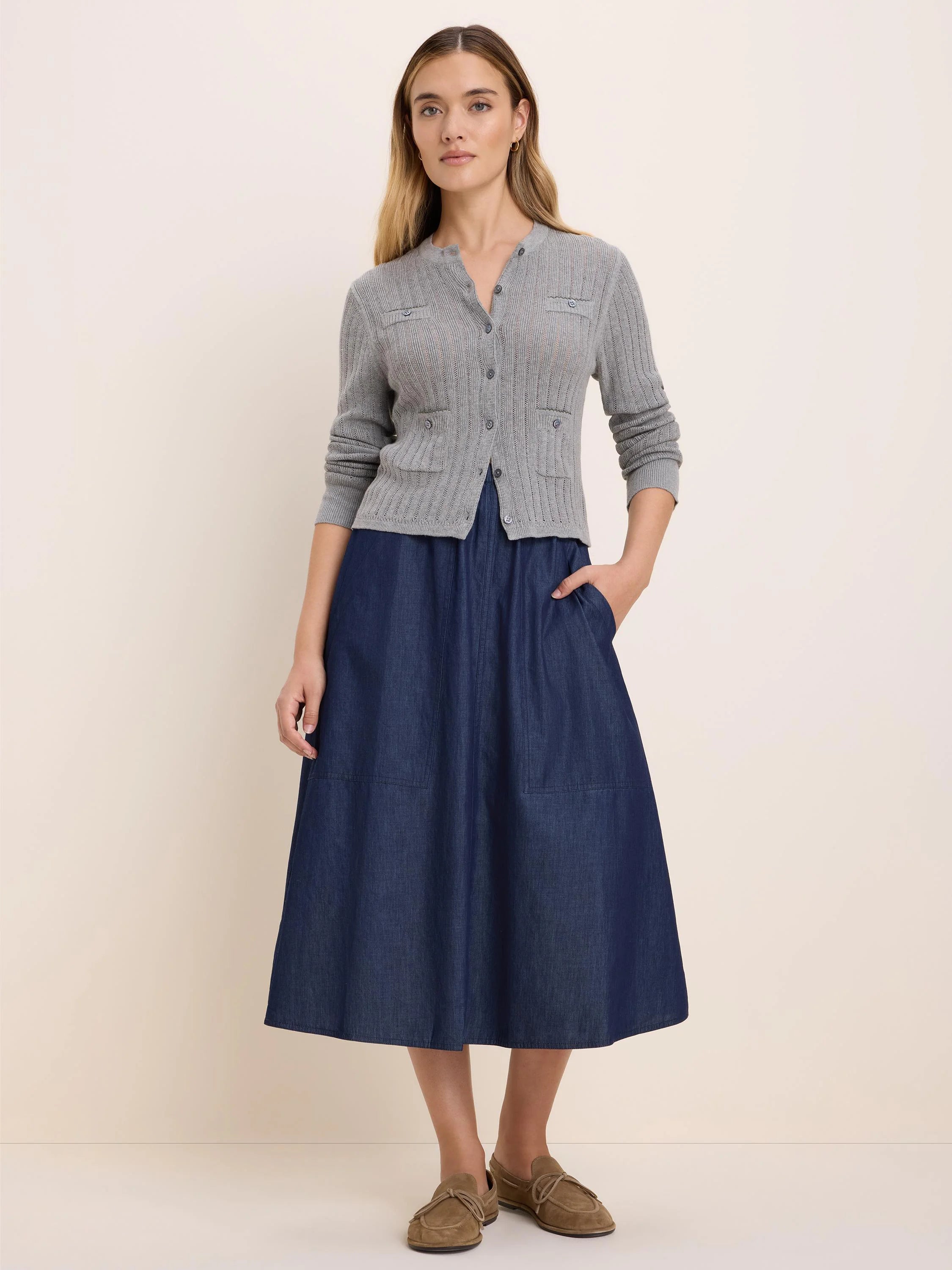 Grey pointelle knit cardigan with a button-up front and two chest patch pockets.