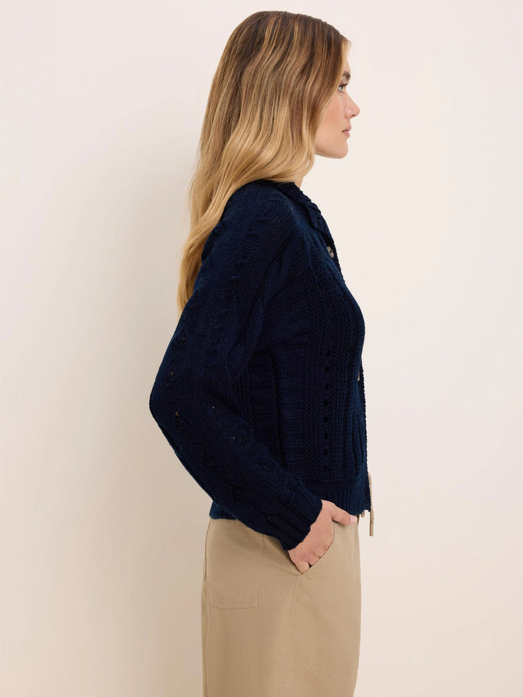 Deep navy cable knit cardigan with textured patterns, including openwork, and small front buttons.