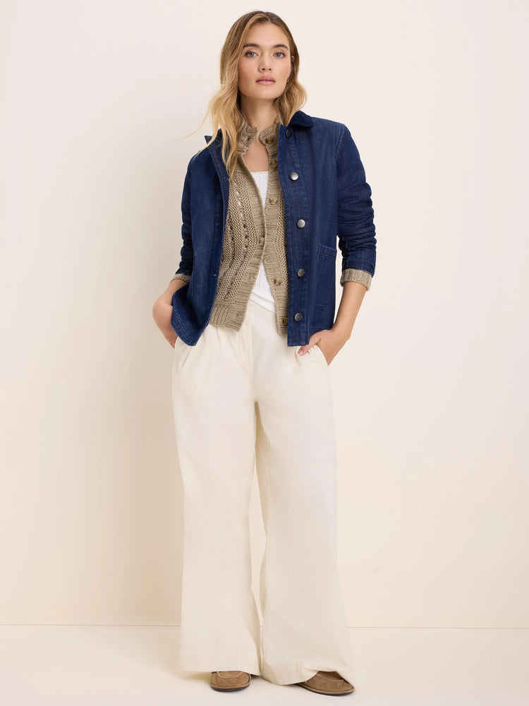 Tan cable knit cardigan with visible buttons.
