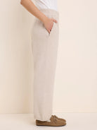 Oatmeal knit wide-leg pants with a ribbed waistband and side pockets.