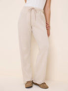 Oatmeal heathered pants with an elastic drawstring waist and wide legs, raw hem.