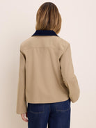 Tan twill jacket, back view, with a navy corduroy collar.