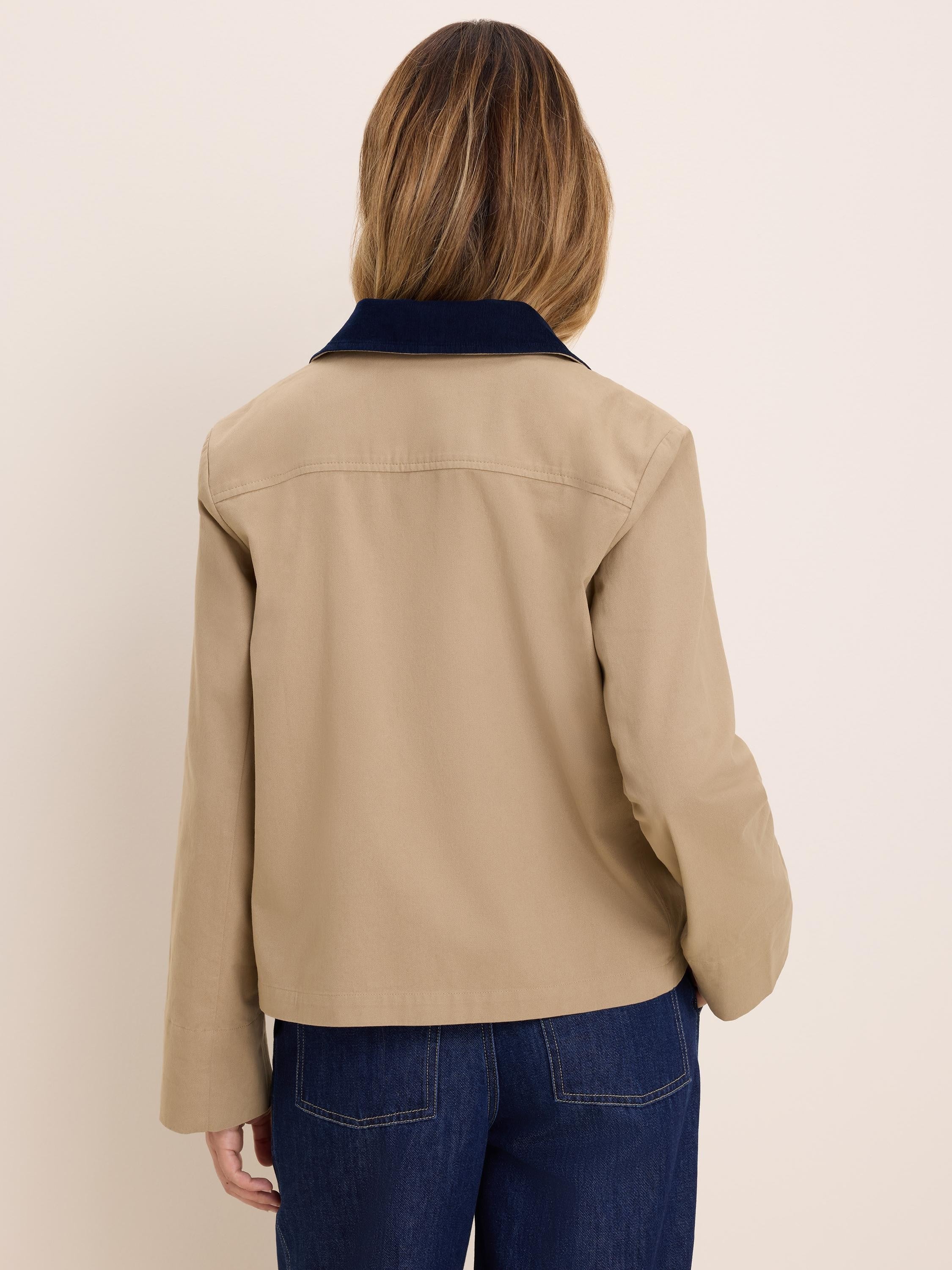 Tan twill jacket, back view, with a navy corduroy collar.