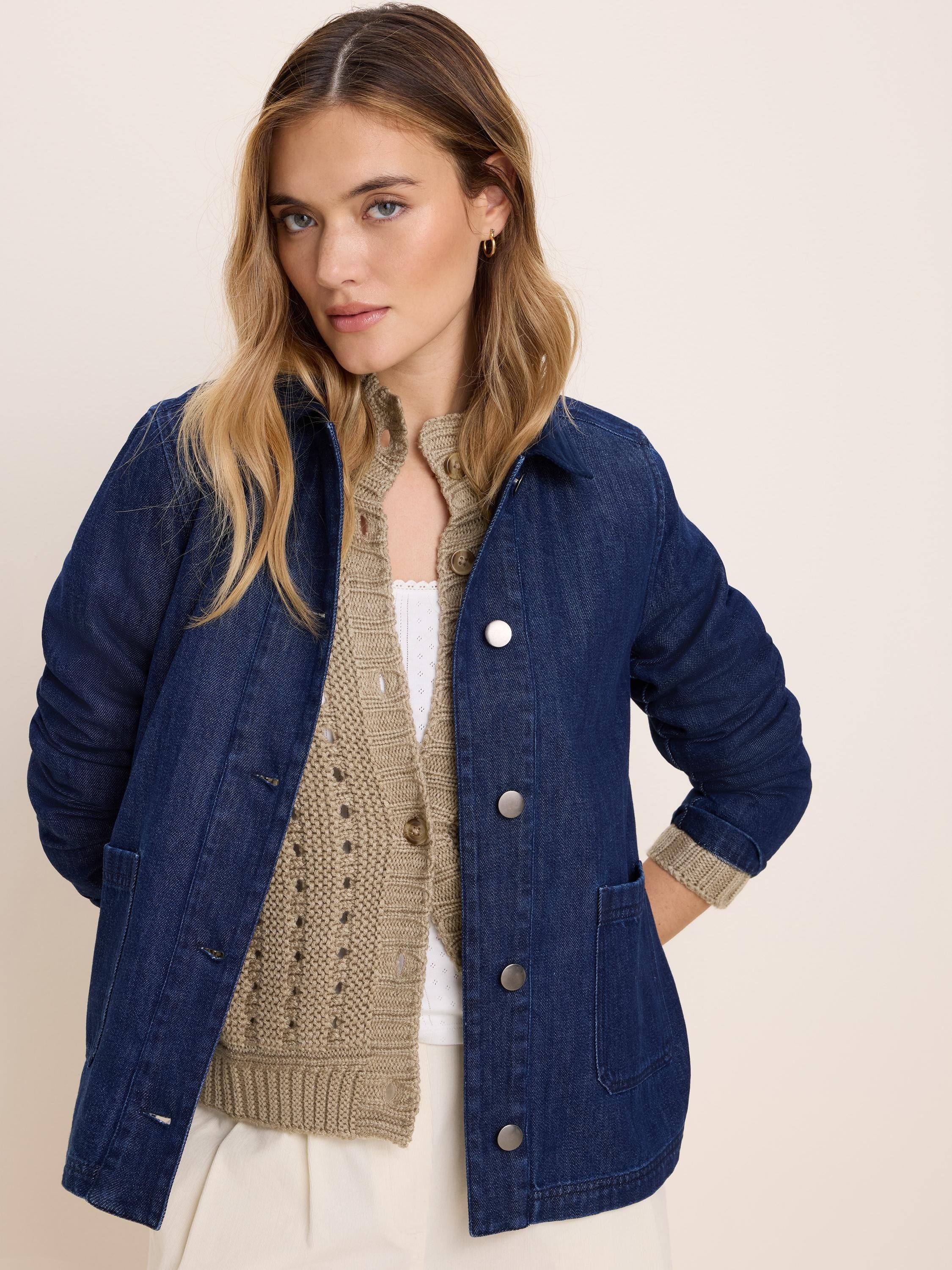 Dark blue denim jacket with silver buttons and two front patch pockets.