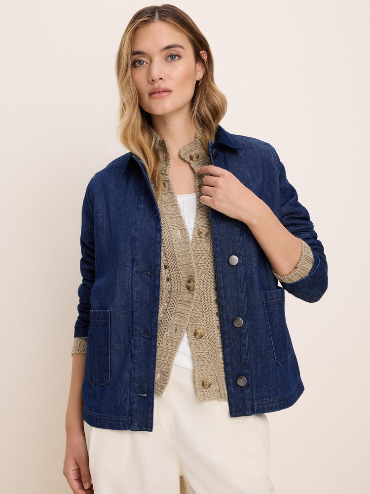 Dark blue denim trucker jacket with a classic collar, silver-toned buttons, and two lower patch pockets.