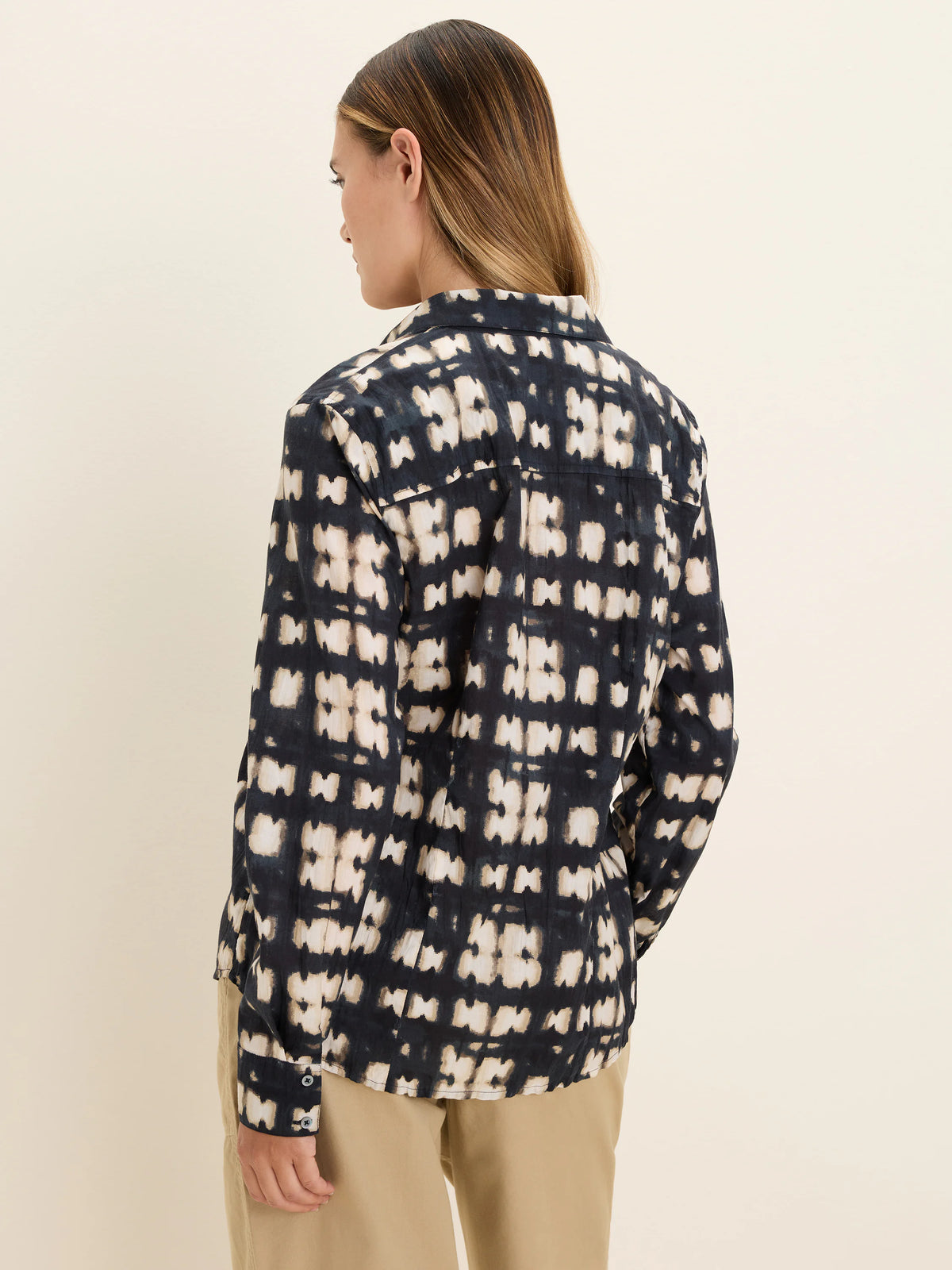 Navy and beige shibori block pattern crinkle shirt, long sleeves, shown from the back.