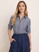Blue dobby stripe shirt with light yellow vertical stripes, button-down front, chest pocket, and rolled sleeves.