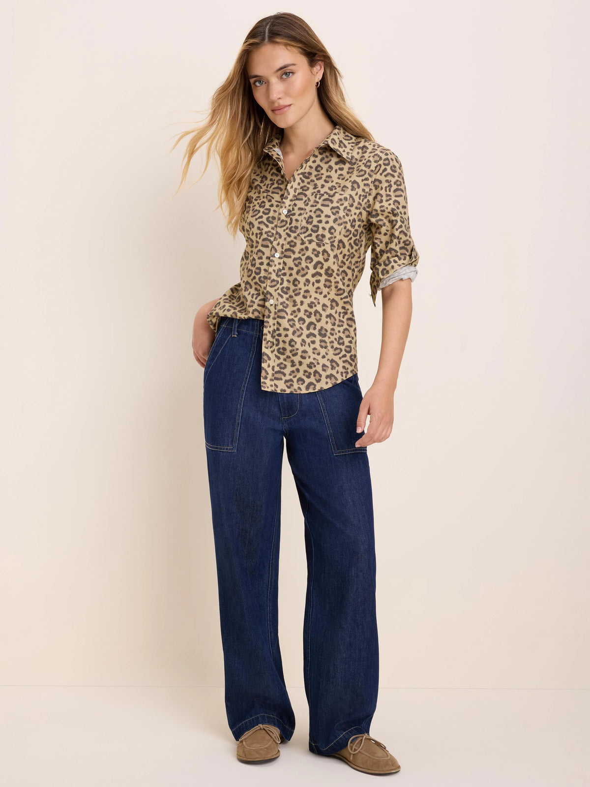 Tan shirt with dark brown cheetah spots. Button-up, collared, with rolled sleeves.