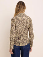 Long-sleeve shirt in beige with dark brown cheetah print, shown from the back.