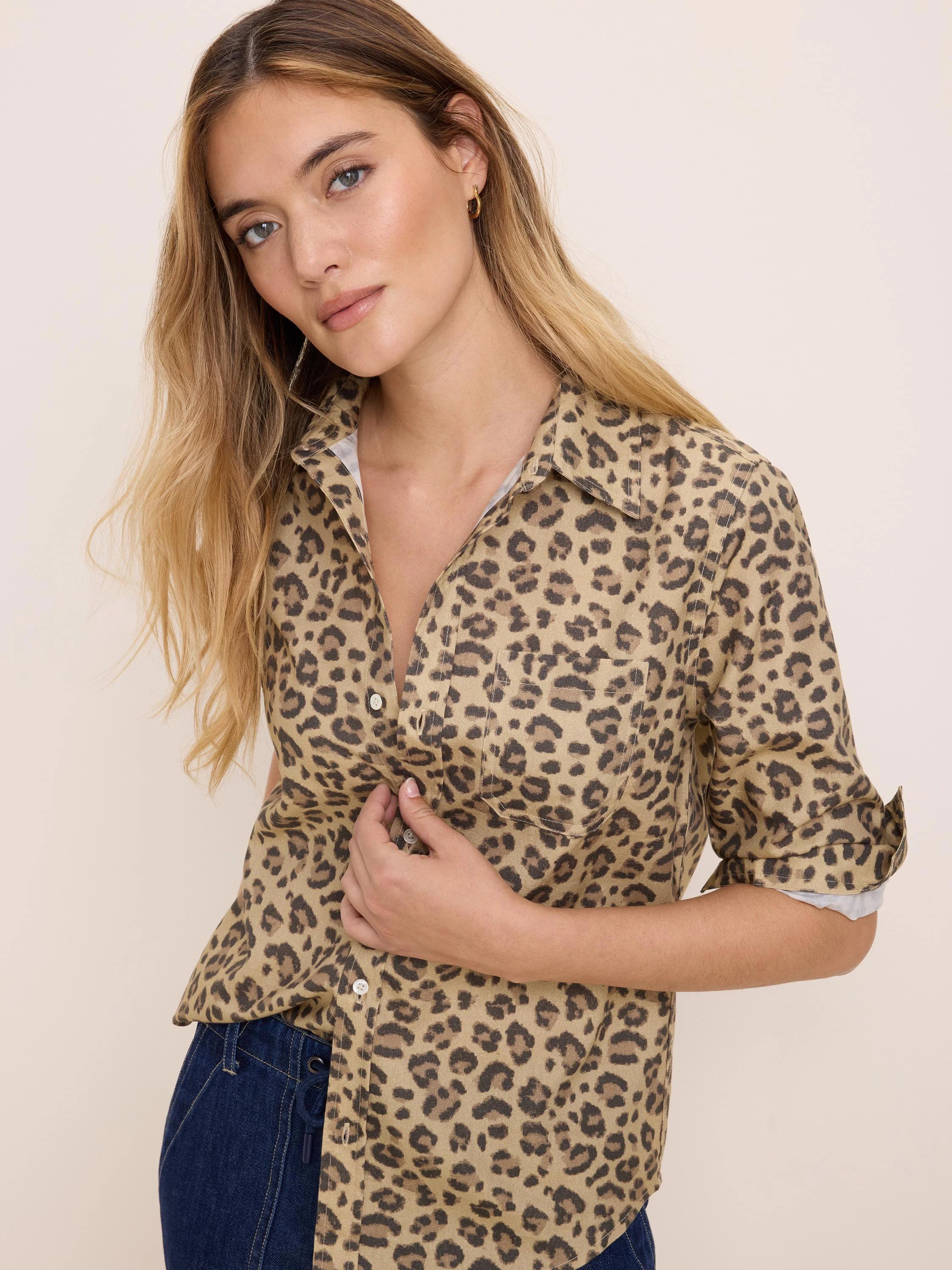 Tan button-up shirt with dark brown cheetah spots, collar, chest pocket, and rolled sleeves.