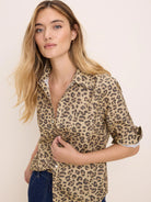 Tan collared button-down shirt with dark brown cheetah spots, left chest pocket, and rolled sleeves.