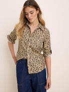 Tan button-down shirt with irregular dark brown cheetah spots and rolled sleeves.