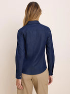 Dark blue denim shirt, back view. Long sleeves with cuffs, back yoke, and vertical seams.