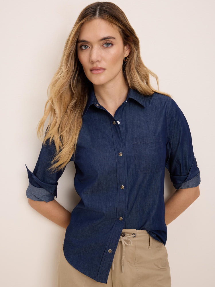 Dark blue denim collared shirt with silver snap buttons, rolled sleeves, and a chest pocket.