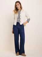Cream baby cord shirt jacket with a collar, dark front buttons, and chest patch pockets.