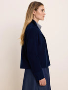 Navy blue baby cord shirt jacket with fine vertical ribs, cropped length.