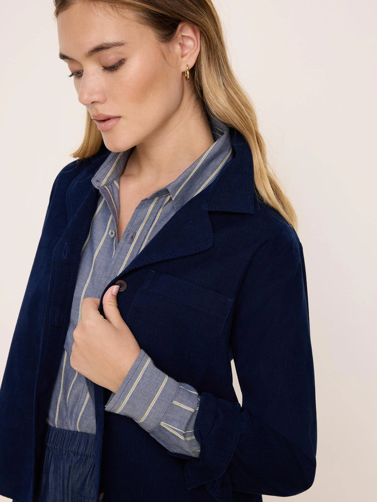 Navy blue corduroy shirt jacket with fine-rib texture, buttons, and a chest pocket.