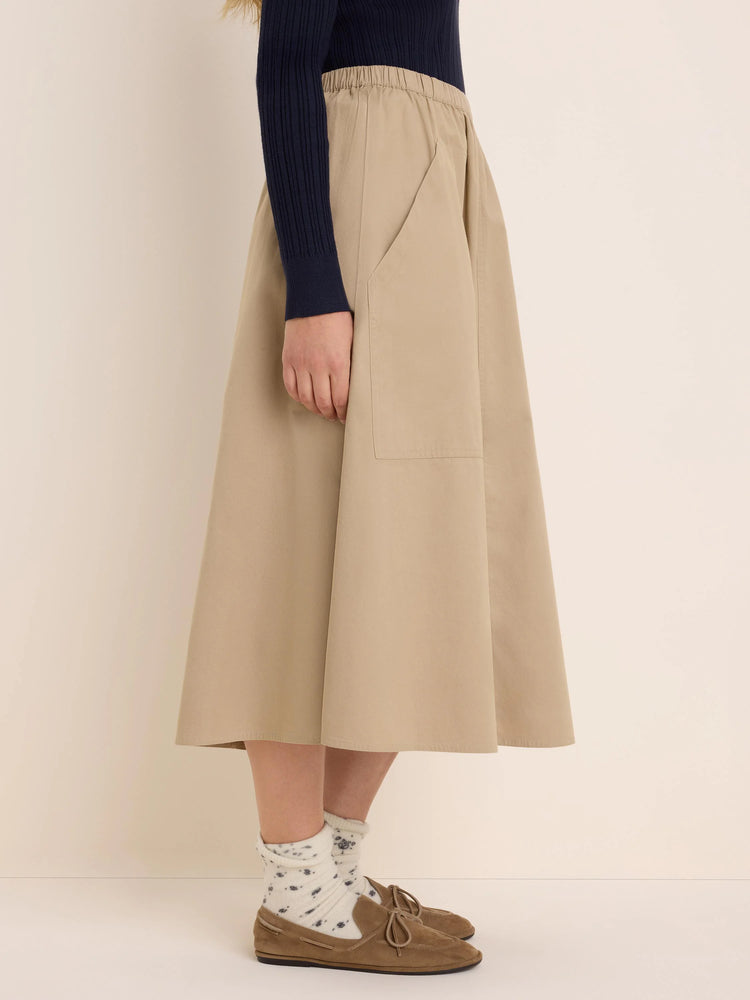 Beige twill cargo skirt. Features an elastic waist, an A-line cut, and a large side patch pocket.