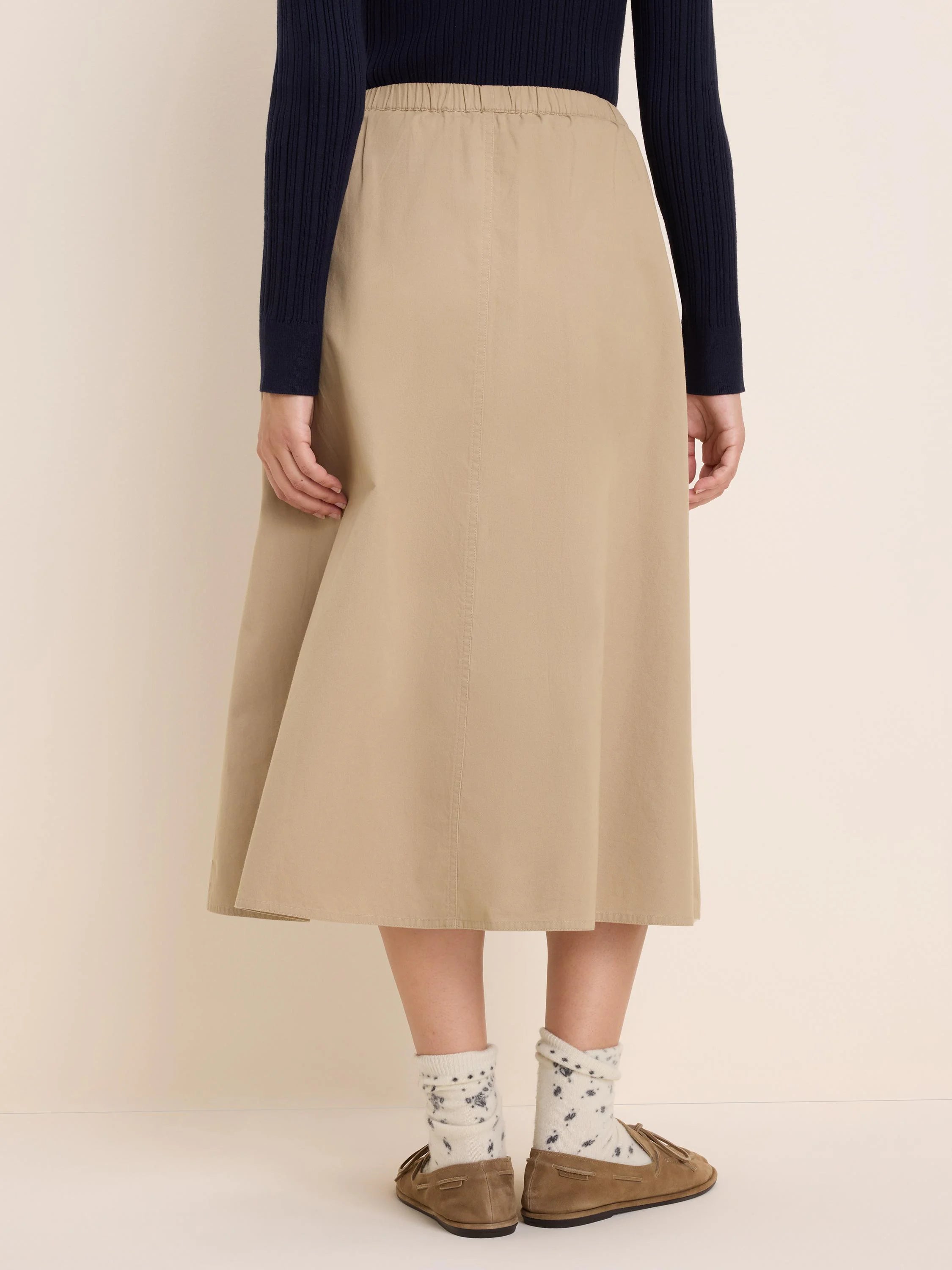 Khaki twill midi skirt with an elasticated waist. Features an A-line silhouette and subtle vertical seams.