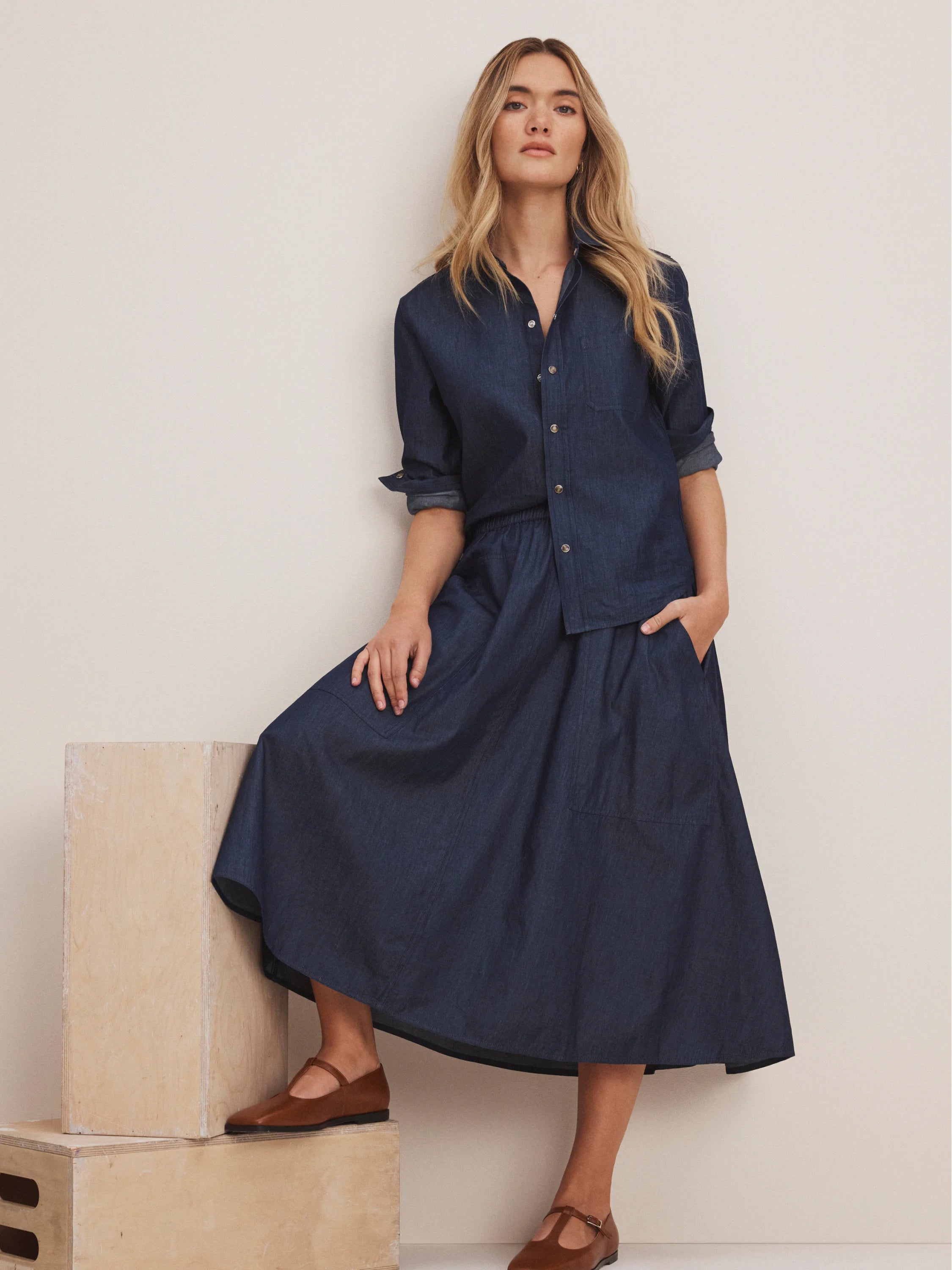 Drapey indigo denim midi cargo skirt with elastic waist & large patch pockets.