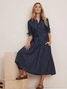 Drapey indigo denim midi cargo skirt with elastic waist & large patch pockets.