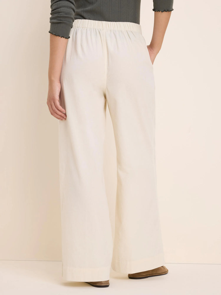 Off-white baby corduroy wide-leg pants with an elastic waist, shown from the back.