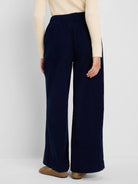 Navy blue baby cord pants with wide legs and an elasticated waist, shown from behind.