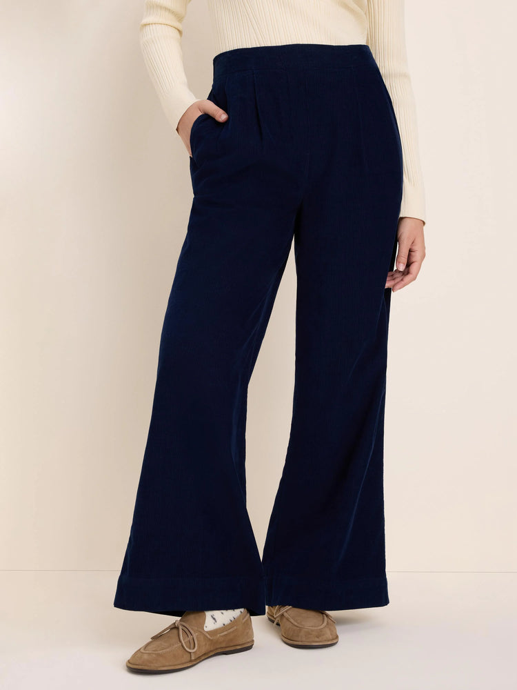 Navy corduroy pants, high-waisted, wide-leg with front pleats and side pockets.