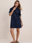 Dark denim collared dress with 3-button placket, cuffed sleeves, and four rectangular patch pockets. Above knee length.