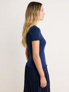 Navy blue pointelle rib tee with short, lettuce-edge sleeves and hem.