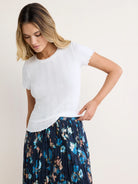 White pointelle rib t-shirt with short, scalloped sleeves and hem.
