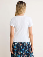 White pointelle rib short-sleeve tee with scalloped trim on sleeves and hem.
