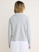 Light grey French terry jacket, back view. Features a collar, long sleeves, and raw edges on the collar and hem.