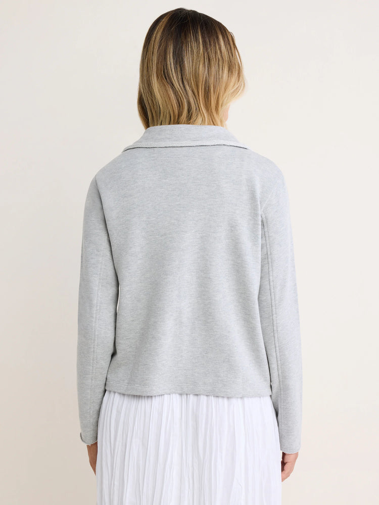 Light grey French terry jacket, back view. Features a collar, long sleeves, and raw edges on the collar and hem.