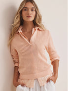 Pale pink mesh polo sweater with an open knit pattern, polo collar, and ribbed cuffs and hem.