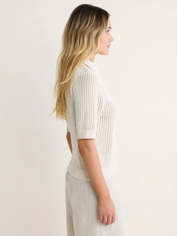 Cream mesh polo sweater with a ribbed collar, short sleeves, and ribbed hem.