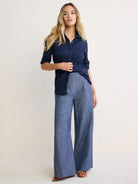 Navy blue collared shirt with crinkled texture, button front, and rolled 3/4 sleeves.