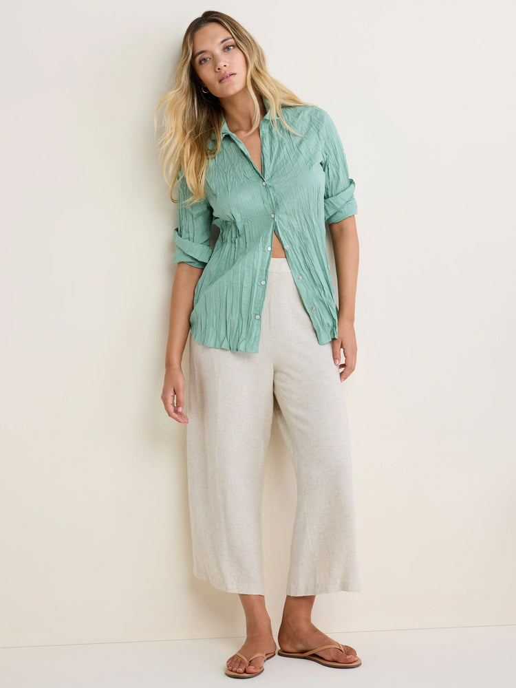 Mint green crinkled cotton button-up shirt with rolled sleeves.