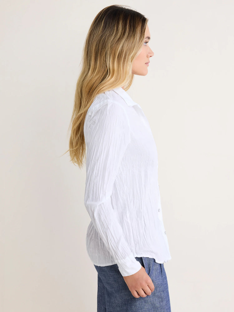 White collared button-up shirt with a crinkled texture. Modeled from the side.