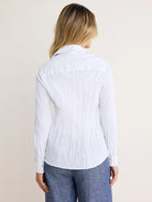 White crinkled long-sleeve shirt, back view. Features two silver cuff buttons.