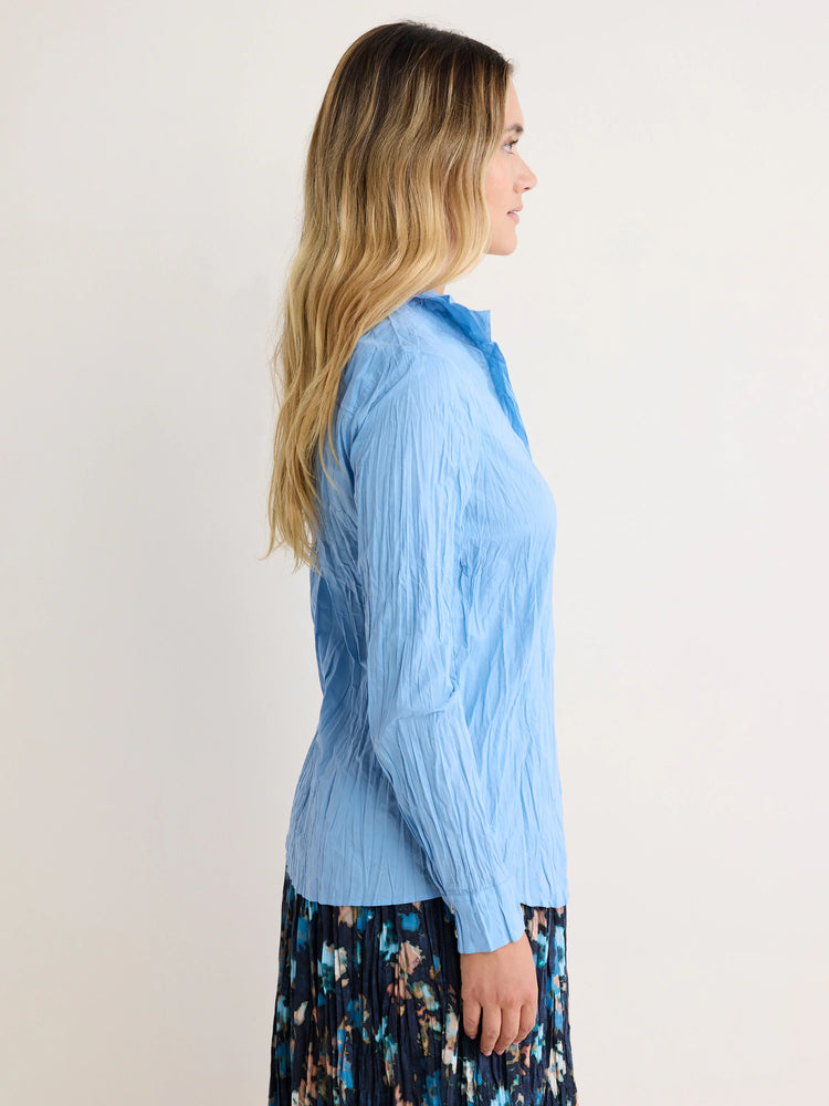 Light blue, crinkled long-sleeve collared shirt.