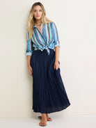 Vertical multi-color striped cotton shirt in shades of blue, green, tan, and black, tied at waist.